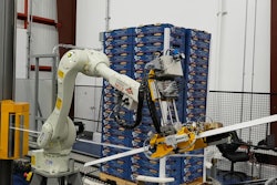 A six-axis articulated robot applies corner boards to the four edges of the pallet, after which it is stretch wrapped.