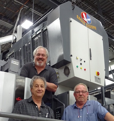 CAPTION: Cold Foil Press – (Top) Mike King, Eagle Systems, (l. to r.) Steve Sifrer and Barney McLin, Colbert Packaging