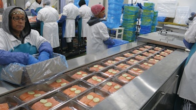Trays are thermoformed on the TFS 707 from roll stock via metal dies designed to accommodate the full range of fish sizes, shapes, and portions, including but not limited to 1x3, 2x3, or 3x2 formats. Fish and any value-add ingredients (pictured is Atlantic salmon with herbed butter) are currently hand-filled, but look for North Coast to apply robotic solutions for tray filling in the future.