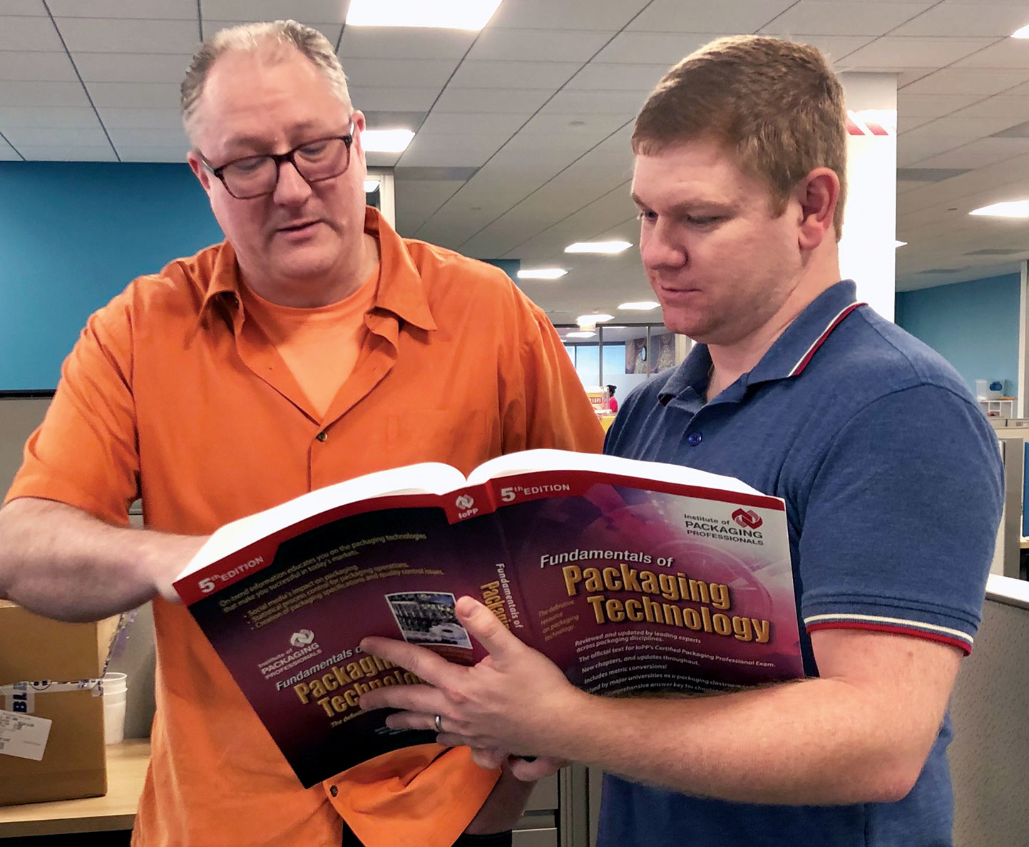 PepsiCo professionals Adam Avis (above left) and Stephen Tyner study IoPP&rsquo;s Certified Packaging Professional text.