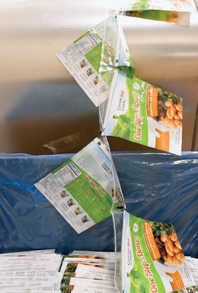 Pre-made bags are strung together and fed into the filling machine from a large container.