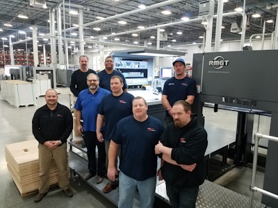 Colbert Operations Manager Jeff MacDougall (far l.), and Production Manager Pat Gibbons (lt. blue shirt) work with Colbert’s press operators on the new RMGT press.