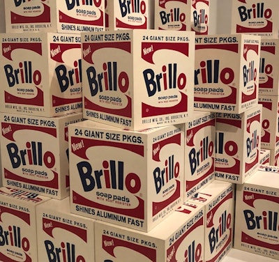 Brillo sculpture from 1964 not only pays homage to beautiful package graphics, the Brillo boxes were produced in a 'factory' and displayed like products on a store shelf.