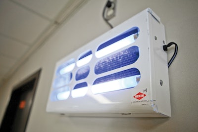 An insect light trap serves as a monitoring device, emitting ultraviolet light to lure and trap flying insects.