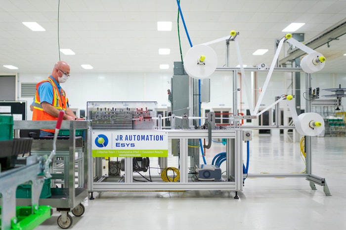 GM engineer work on final testing and validation of medical mask assembly line from JR Automation.