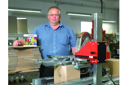 Production manager, Klaus Kailow, in front of the Soco System case sealer. It top and bottom seals simultaneously and can be extended with, e.g., a bottom flap folder.