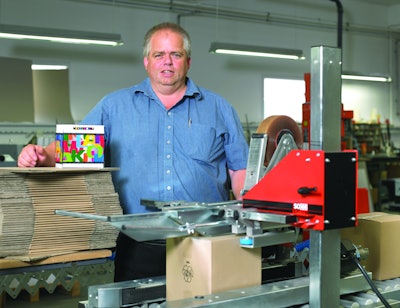 Production manager, Klaus Kailow, in front of the Soco System case sealer. It top and bottom seals simultaneously and can be extended with, e.g., a bottom flap folder.