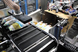 The Spider 200i from BluePrint Automation uses a multi-axis robot to pick snack bags on-the-fly and vertically case pack them into a cassette that forms a vertical pack pattern.