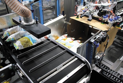 The Spider 200i from BluePrint Automation uses a multi-axis robot to pick snack bags on-the-fly and vertically case pack them into a cassette that forms a vertical pack pattern.