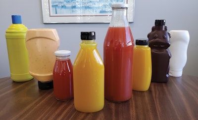 The 14-head filler and 6-station capper accepts an impressive variety of bottle types (shown) as well as either a threaded or lug closure.