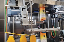 The shrink-sleeve labeler features servo drive technology and applies either a full-body or a neck label (shown left).