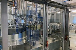 Transfer of PET bottles from blowing to filling to capping is all done by star wheels that grip bottle necks, so no bottle platforms are needed.