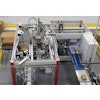 Shown here is one of four case packers that receive bags (lower left) and then discharge finished cases (lower right) into a spiral conveyor takeaway.