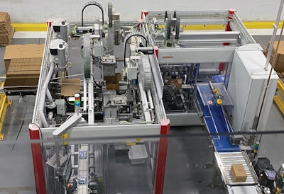 Shown here is one of four case packers that receive bags (lower left) and then discharge finished cases (lower right) into a spiral conveyor takeaway.