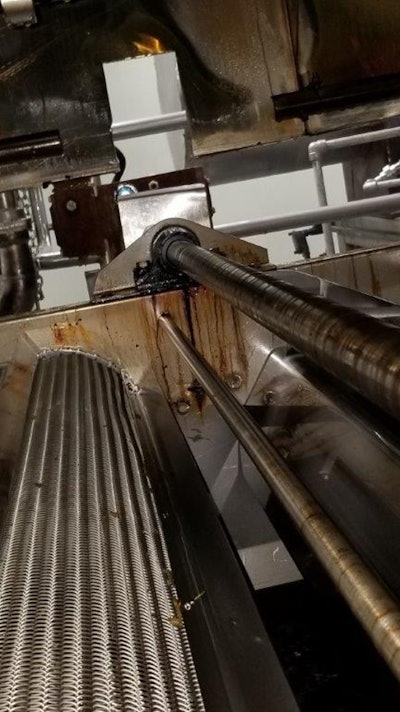 The Graphalloy pillow block sits at the far end of the shaft, in the fryer.