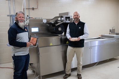 Jason Sawyer, associate professor in Auburn’s Department of Animal Sciences, and Tom Bonner, protein market director at Winpak and an Auburn alumnus, display meat products packaged with the VarioVac Rollstock Packaging Machine provided by Winpak.