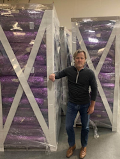 Flopak Managing Partner, Mike Greene, inspects pallets of floral wrap shipped with the patent pending Paklite™ Shipping System.
