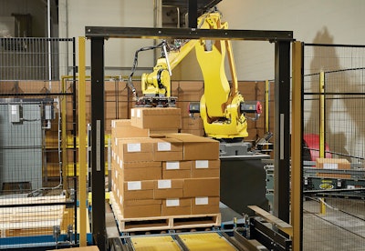 A Fanuc robot palletizes packaged blocks, still warm from processing, in a “chimney” format to facilitate cooling.