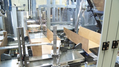 XTS greatly reduces jams and downtime as it moves perfectly stacked pizzas into cases. Shown here is a freshly erected case on the right and two stacks of pizzas about to be pushed into the case on the left.