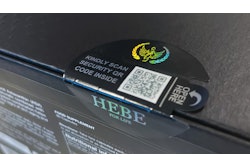 A holographically printed, tamper evident label with external QR code and die-cut tear strip spans the gap between shipper sidewalls and top.