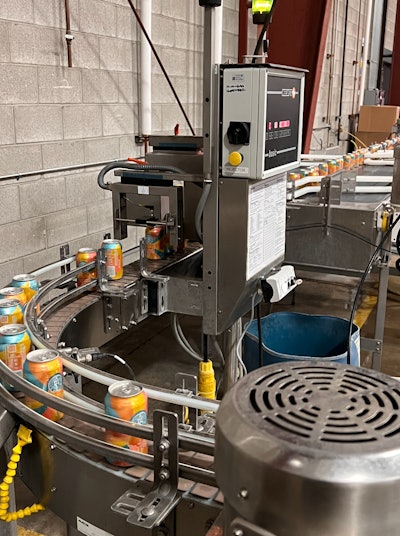 Custom conveyance brings the two Wild Goose lines together and sends cans through a Heuft Basic low fill/low pressure detector.