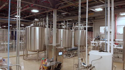Amway’s 8,000-gal dilution tanks, shown with the mixproof valve bank in the forefront.