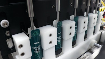 Formed packets being raised into the filling station.