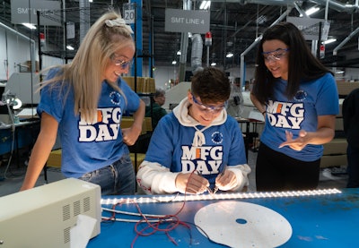 Students on Manufacturing Day do quality control checks on LED lighting systems on the factory floor at LumaSmart, a lighting manufacturer in Michigan.