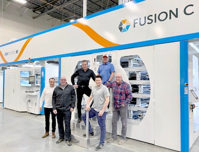 Aspen Press & Packaging team members show the installed Fusion C flexographic printing press from PCMC.