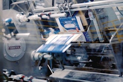 Printed paperboard cartons are opened out of magazines of 2D blanks by way of mechanical gripers, plus an “elegant” air-assist carton opening feature to ensure the cartons fully open.