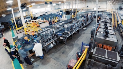 Downstream of the Meridian XR MPS-300 (upper right middle), operators attend to the lane guardrails at the point of a 180-deg turn on the line after cartoned product is laned.