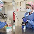 Operators at Mother’s Milk Bank induction seal 100-mL rigid bottles prior to pasteurization.