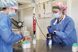 Operators at Mother’s Milk Bank induction seal 100-mL rigid bottles prior to pasteurization.