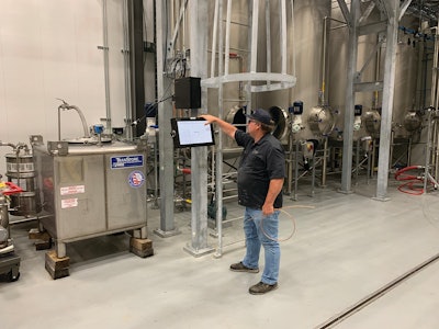 Maintenance Manager Dan Hatfield checks system parameters in the blending room.