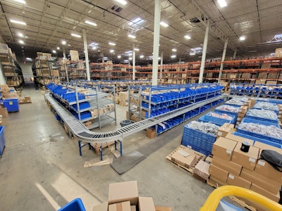 The previous layout of the picking and packing line featuring elbow sections that are smaller than the straight-line tracks on the previous configuration.