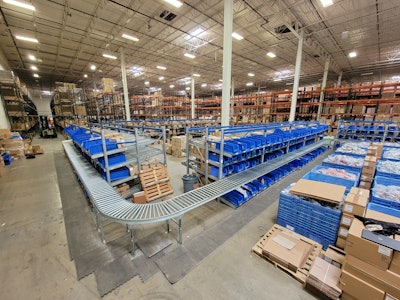 The updated layout in this fulfillment center keeps gravity fed cases moving smoothly through picking station, around elbows, and down to taping and palletizing.