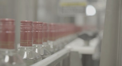 Smirnoff glass bottles on conveyor