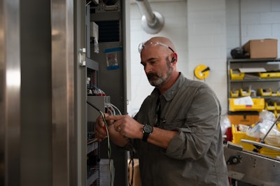 Seth Smith, Assembly Technician, wiring an electrical panel.