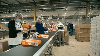 Operators case-pack squeezable smoothie products for club store distribution.