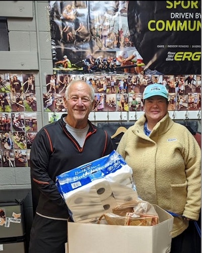 Mark Rosenstein of Foundation Fitness Club and Pinnacle Packaging President Nicole DeJoris collect personal items and non-perishable foods to help The Outreach House in Lombard during the holiday season.