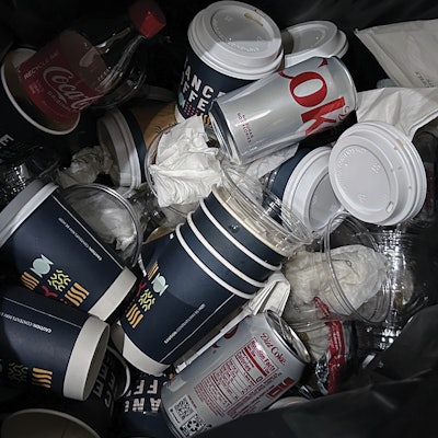 A real image of a trash bin at a sustainable packaging conference.