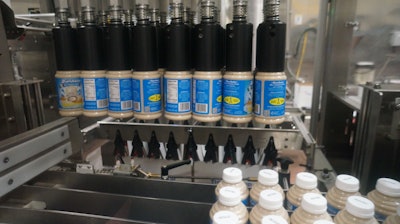 Shown here are 16-oz PET bottles being carried toward the loading station of the case packer.