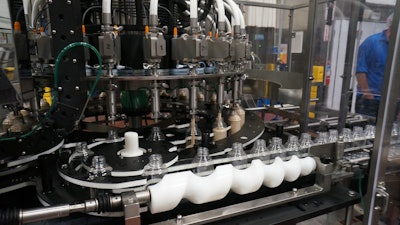 The monoblock filler/capper handles 16-oz bottles at 200/min and 64-oz at 150/min.