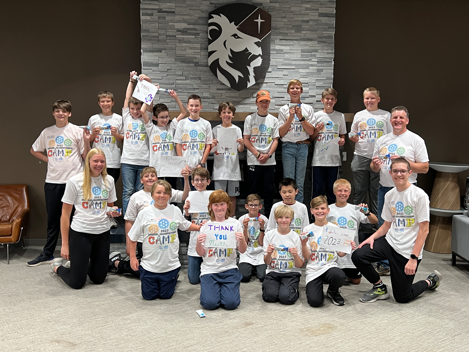Summer Manufacturing Camp attendees and supervisors, including Todd Kruse (right), pose for a group photo at Legacy Christian Academy.