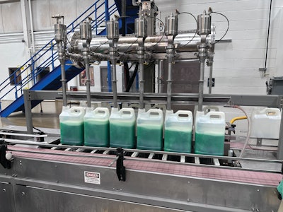 Filling is done on six-head fillers where lances descend on ball screws into the empty bottles. Top filling, bottom filling, or a hybrid of the two methods called tracking can be used to fill the bottles depending on product characteristics. Each bottle sits on an individual load cell, and filling is metered by weight rather than volume or fill line.