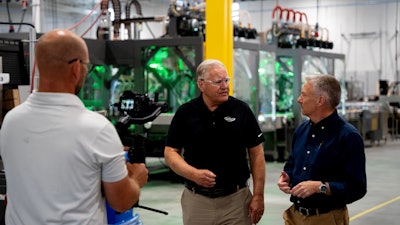 Tom Costello (right), Economics Reporter for NBC News, interviewed Dale Andersen (center), president and CEO of Delkor Systems.