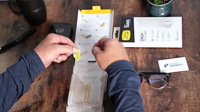 The sleeve to which the tool is adhered folds out and is printed with step-by-step instructions on how to use the installation tool.