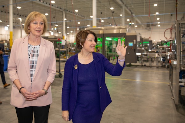PMMI Chairperson Patty Andersen (left) tours Delkor's facility with Senator Amy Klobuchar.