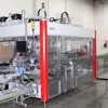 Carolyn Hardy (in blue) and Bernadette Fuller, a University of Tennessee Solutions Consultant, discuss the day’s packaging run using the SOMIC 424 case packing system.