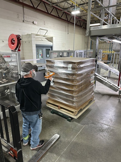 Workers scan labels on each pallet to upload data on inventory used for the system’s assembly reconcile and put-away app.